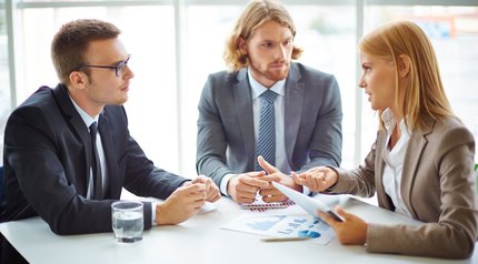 businesspeople-having-meeting-around-table