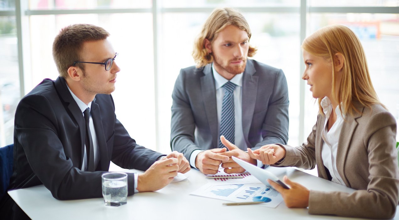 businesspeople-having-meeting-around-table